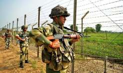 Indian Border Security Force (BSF) soldiers take up positions at an outpost along a fence at the India-Pakistan border in R.S Pora south-west of Jammu on October 2, 2016. India has evacuated thousands of people near the Pakistani border in Punjab state following the military raids on militant posts, which provoked furious charges of "naked aggression" from Pakistan. The move followed a deadly assault on one of India's army bases in Kashmir that New Delhi blamed on Pakistan-based militants, triggering a public outcry and demands for military action. / AFP PHOTO / TAUSEEF MUSTAFA